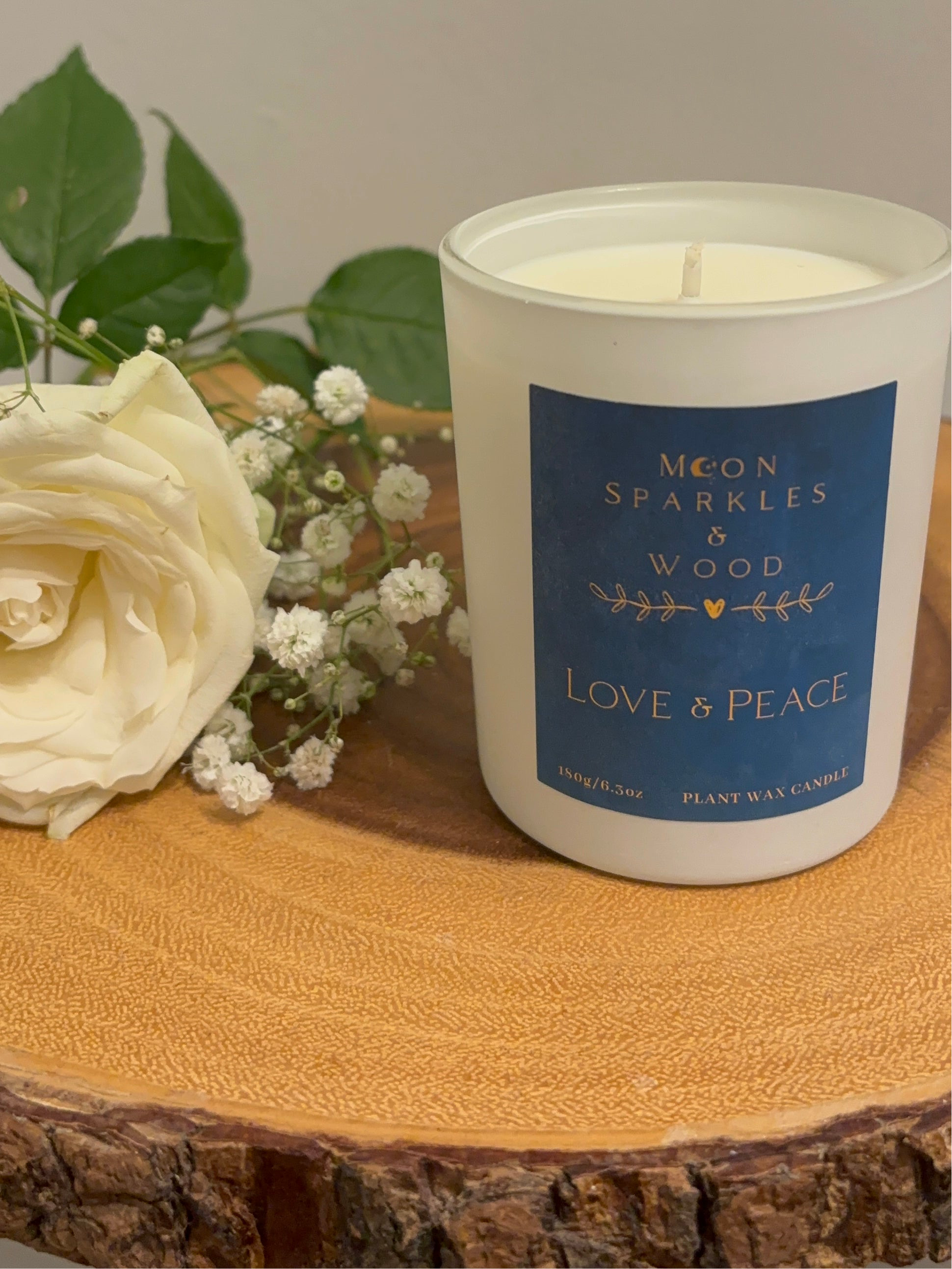 Moon sparkles and wood hand poured soy wax candle scented Love and Peace essential oil blend. Wedding candles next to white rose